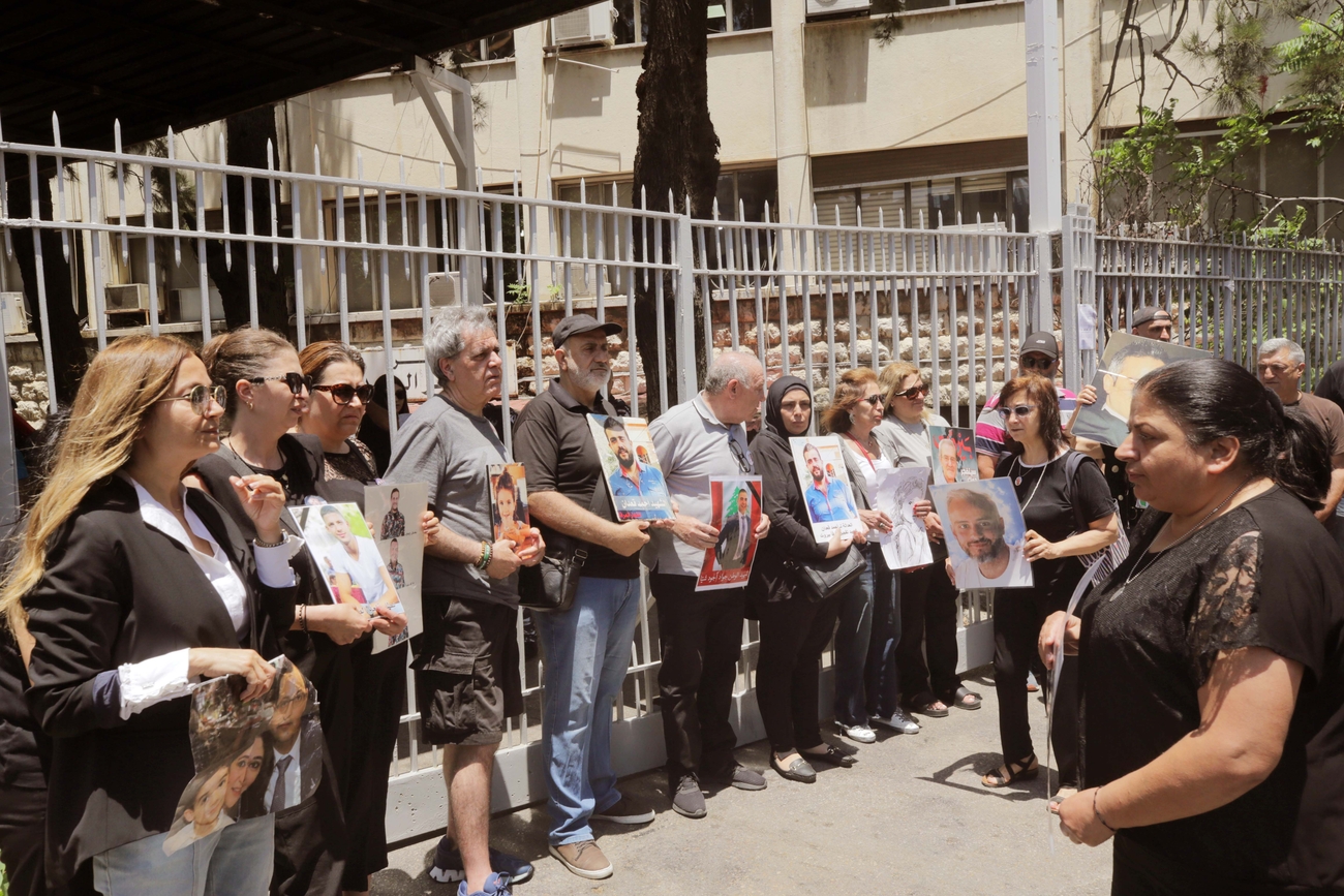 Families of the victims of the port explosion stand outside the Justice Palace