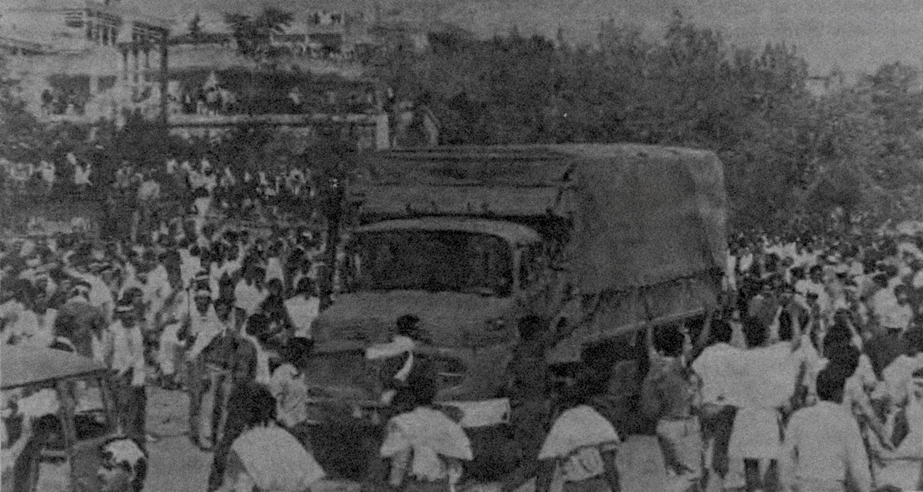 Crowd gathers around an Israeli military truck