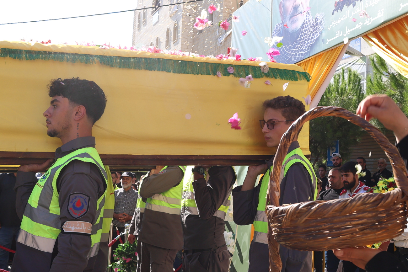 Men carry coffin