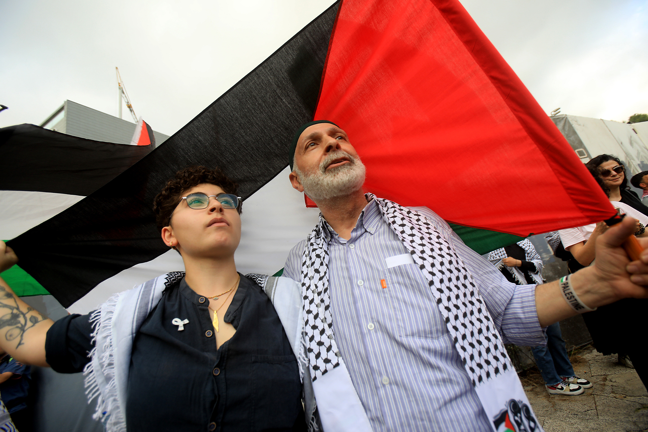 Protesters carry Palestinian flag