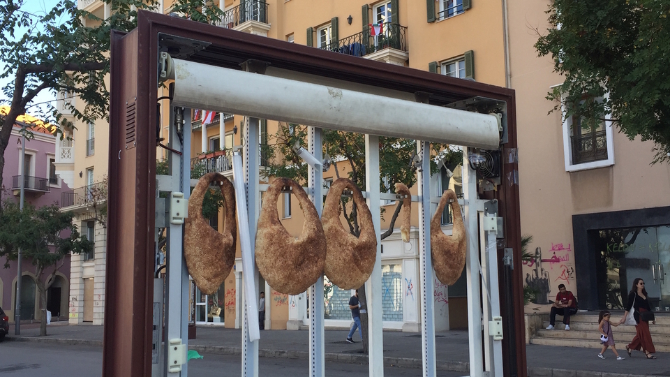 Ka'ak left hanging on a broken street sign for anyone in need. Beirut, Lebanon. October 29, 2019. (Bachir Asmar/Fawra)