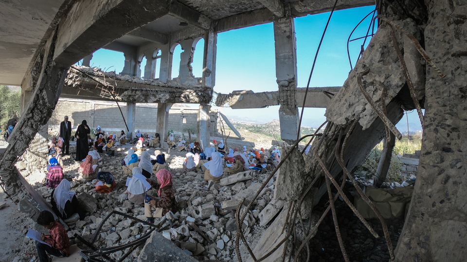 Children study in the rubble of their school that was destroyed by the violent war in the city of Taiz, Yemen. December 27, 2018. (Akram Alrasny/Shutterstock)